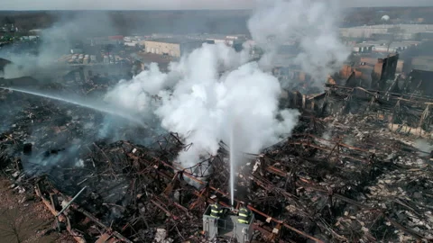 Aerial view of firemen fighting with fire near biulding. Wide shot Stock Footage 232709557