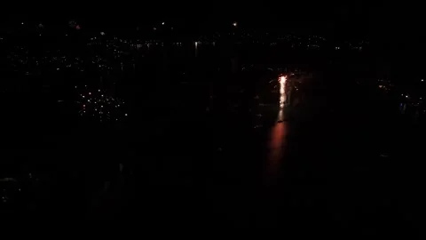 Aerial view of fireworks exploding above the city at night, marking the arrival Stock Footage 325950483