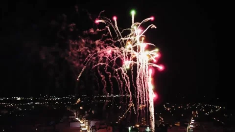 Aerial View of Fireworks Exploding at Night Sky Above Cityscape, Drone Shot Stock Footage 222727552