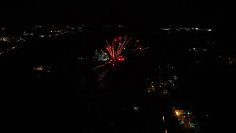 Aerial view of fireworks exploding over a city at night 動画素材 328923466