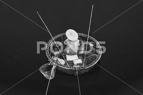 Aerial view of fisherman on circle boat with straw hat