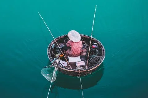 Aerial view of fisherman on circle boat with straw hat "Non la" in Vietnam Stock Photos