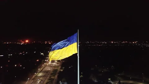 Aerial view. The flag of Ukraine develops in the wind at night.  Stock Footage 196386192