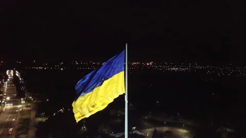 Aerial view. The flag of Ukraine develops in the wind at night.  Stock Footage 196387042