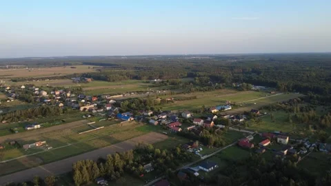 Aerial View of Flat Farmland Fields and Scattered Houses in the Countryside Stock Footage 344851382