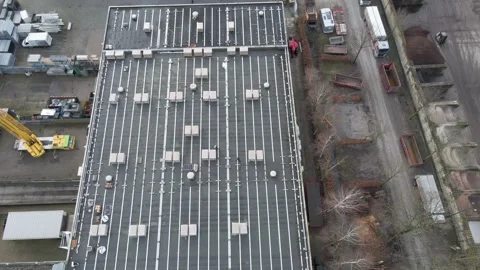 Aerial view of flat industrial building roof with skylights and solar panel.. Stock Footage 337388252