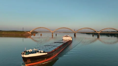 Aerial view. Flight around of dry cargo ship sails on the river at sunset.  Stock Footage 234582912
