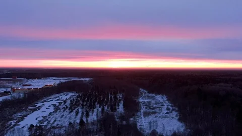 Aerial view flight with climbing over winter forest in twilight. Stock Footage 122689261