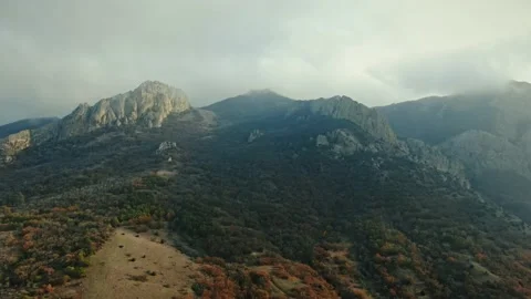 Aerial view. Flight to the Mountains on top of which are clouds. Autumn. Mainly Stock Footage 150588809