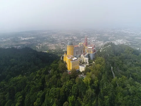 Aerial view flight out of clouds revealing Pena Palace located in Sintra 4k Stock Footage 80422164