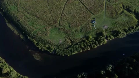 Aerial View: Flight over the Beautiful River and Green Wood. Sunset soft light Stockbeeldmateriaal 159155434