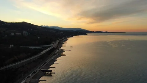 Aerial view flight over the calm sea towards the setting sun Video stock 125967963