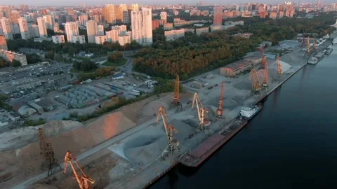 Aerial view flight over cargo port in the big city. Unloading a merchant ship. Stock Footage 137985409