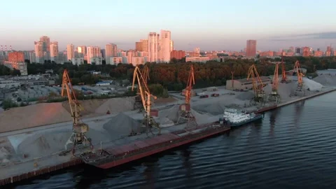 Aerial view flight over cargo port in the big city. Unloading a merchant ship. Video stock 137986129