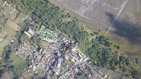 Aerial view flight over Cemoro Lawang, small village in morning mist. Which Stock Footage 169931671