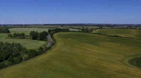 Aerial view Flight Over a country road between Agricultural Fields in germany Stock Footage 63880595