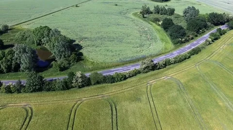 Aerial view - Flight Over a country road between Agricultural Fields in germany Stock Footage 63884151