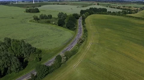 Aerial view -  Flight Over a country road between Agricultural Fields in germany Stock Footage 63884576