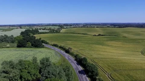 Aerial view -  Flight Over a country road between Agricultural Fields in germany Stock Footage 63884992