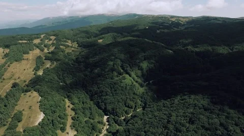 AERIAL view. Flight over forest road in mountains Stock Footage 68887714