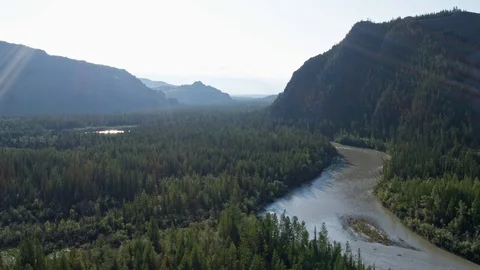 Aerial view flight over the forest river hills. Reflection of the sun's rays 4k Stock Footage 124743774