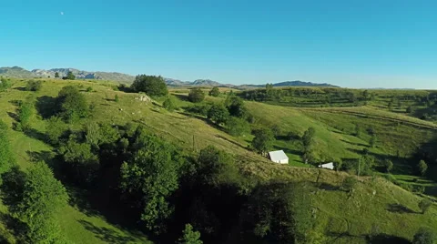 Aerial View, flight over green hills and countryside road and village houses Vidéo 67266555
