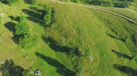 Aerial View, flight over green hills and countryside road and village houses Vídeos de archivo 67266765