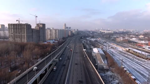 Aerial view flight over a high-speed highway in a big city at dawn. Stock Footage 144300817