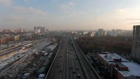 Aerial view flight over a high-speed highway in a big city at dawn. Stock Footage 144300819