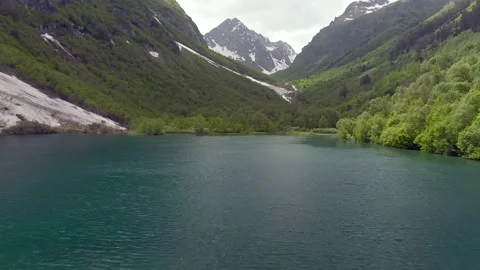 Aerial view flight over the mountain lake in the gorge. Video stock 156346733