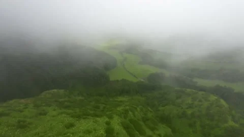 Aerial View Flight over mountain peak top forest heavy fog Azores Stock Footage 221825481