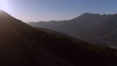 Aerial view flight over the mountains towards a colorful magic sunset. Video stock 141609536