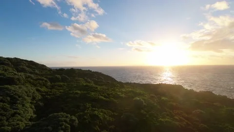 Aerial view flight over mountains and oceans to meet the setting sun Azores Stock Footage 221564745