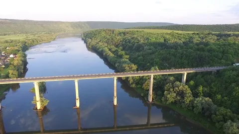 Aerial view. Flight over the river and bridge. Suny day. Amazing view green tree Stock Footage 73096026