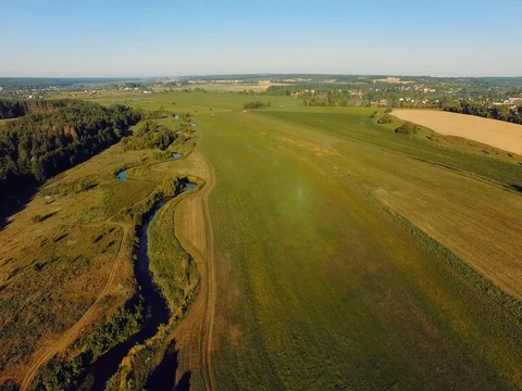 AERIAL VIEW: Flight over the river at sunrise 動画素材 77596306