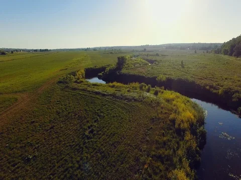 AERIAL VIEW: Flight over the river at sunrise Stock Footage 77596319