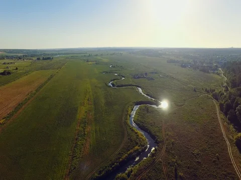 AERIAL VIEW: Flight over the river at sunrise Video stock 77596340