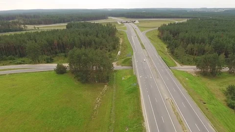 Aerial View. Flight over the road with cars near the forest. Aerial drone shot. Vídeo Stock 78558985
