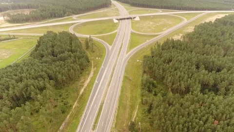 Aerial View. Flight over the road with cars near the forest. Aerial drone shot. Vídeo Stock 78560721