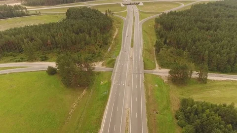 Aerial View. Flight over the road with cars near the forest. Aerial drone shot. Stock-Footage 78564325