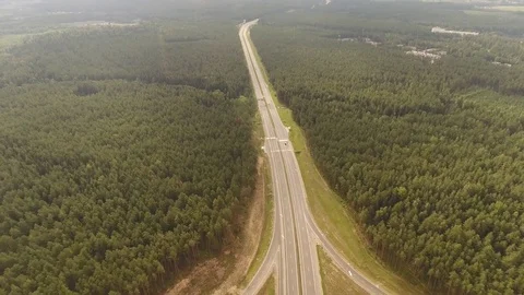 Aerial View. Flight over the road with cars near the forest. Aerial drone shot. Stock-Footage 78626980