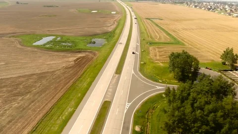 Aerial View. Flight over the road with cars near the fieldt. Aerial drone shot. Stock-Footage 78924864