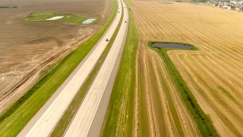Aerial View. Flight over the road with cars near the fieldt. Aerial drone shot. Stock-Footage 78925780