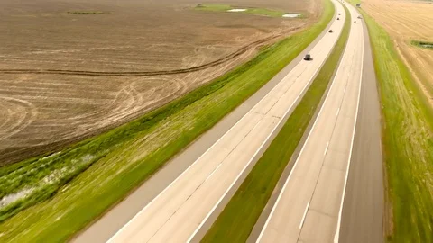Aerial View. Flight over the road with cars near the fieldt. Aerial drone shot. Stock-Footage 78927805