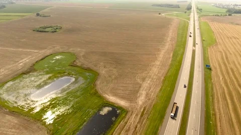 Aerial View. Flight over the road with cars near the fieldt. Aerial drone shot. Stock-Footage 78928855