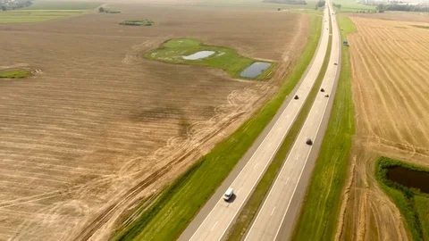 Aerial View. Flight over the road with cars near the fieldt. Aerial drone shot. 動画素材 78930480