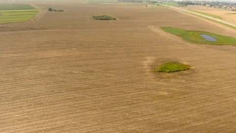 Aerial View. Flight over the road with cars near the fieldt. Aerial drone shot. 動画素材 78932136