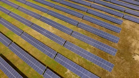 Aerial view  flight over solar panels modules on green meadow Stock Footage 62934471