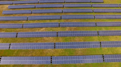 Aerial view  flight over solar panels modules on green meadow Stock Footage 62934476