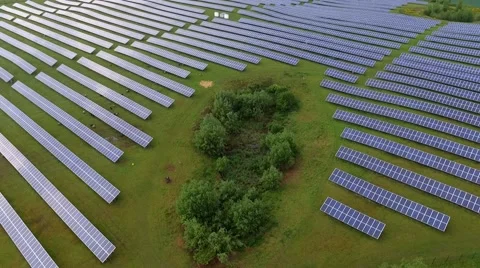 Aerial view  flight over solar panels modules on green meadow Stock Footage 63526777